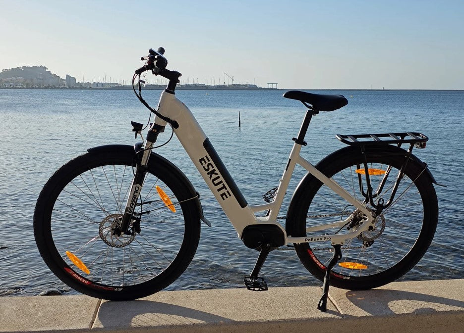 Eskute Polluno Pro eBike against a backdrop of calm sea waters, highlighting its sleek white frame.