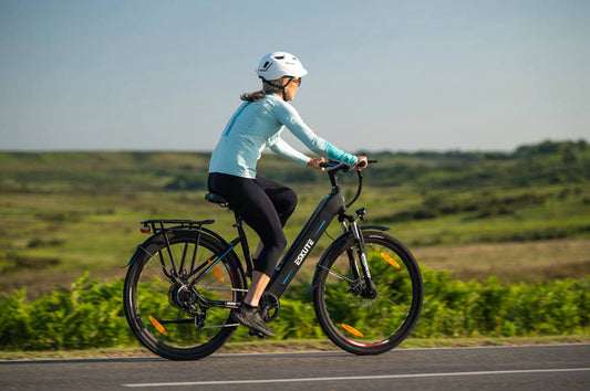 A lady riding the Eskute Star Electric Bike with Good safety measures and gears.