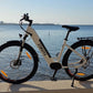 Eskute Polluno Pro eBike against a backdrop of calm sea waters, highlighting its sleek white frame.