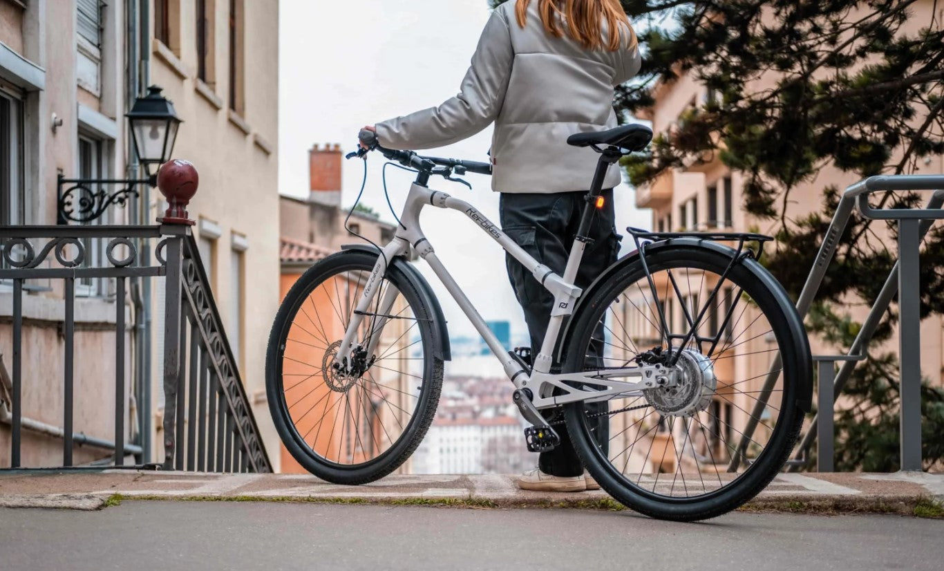 Urban Boost Bike on a cobblestone bridge, blending urban commute with historic charm