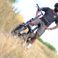 Cyclist riding Eole X Pro through grassy field, showcasing off-road capability.