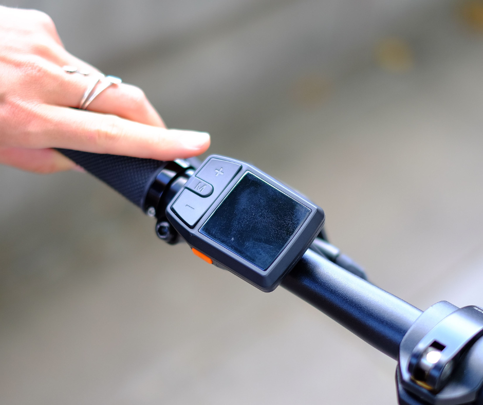 Detailed close-up of the Eole X ebike's handlebar with integrated control display and ergonomic grips for a comfortable ride.