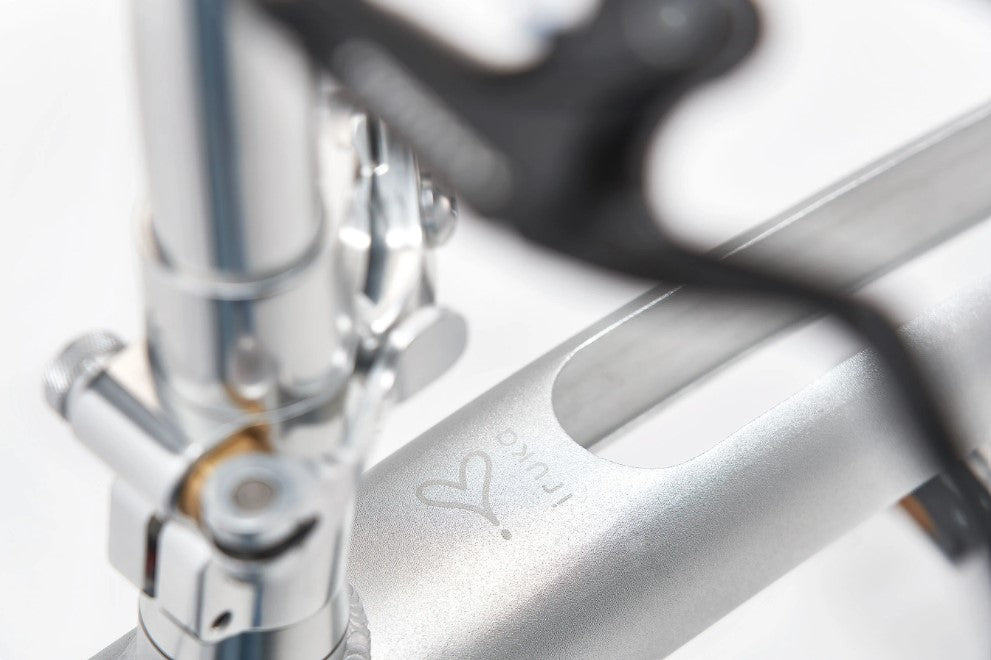 Close-up of the Iruka C Ebike's sleek handlebar attachment and branding details.