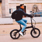 Urban commuter riding the Eole S folding ebike on city streets, demonstrating its practicality for daily use.