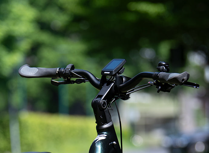 Close-up of the Lapis ebike handlebar with LCD display, ergonomic grips, and control buttons, emphasising the bike's advanced technology.