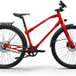 Red Urban Boost bicycle posed against a white backdrop, highlighting its vibrant color and stylish build.