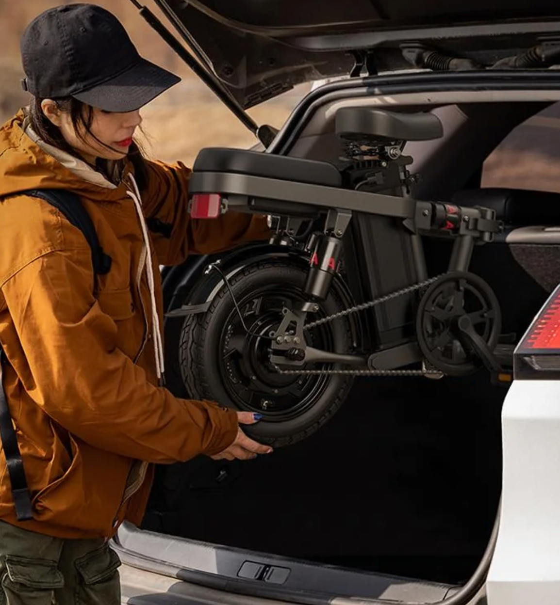 Woman folding Engwe T14 Ebike into car trunk, highlighting its compact design and portability.