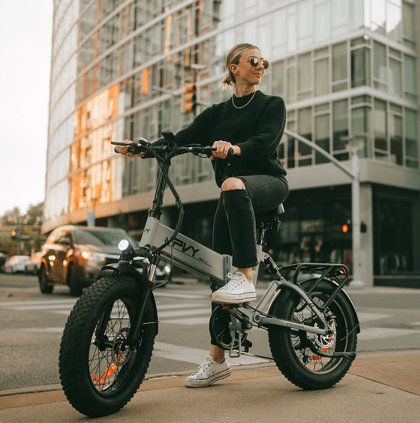 Stylish woman riding on the PVY Z20 Ebike in the city.